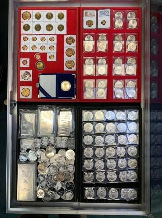 A display case filled with lots of coins and silver bars.