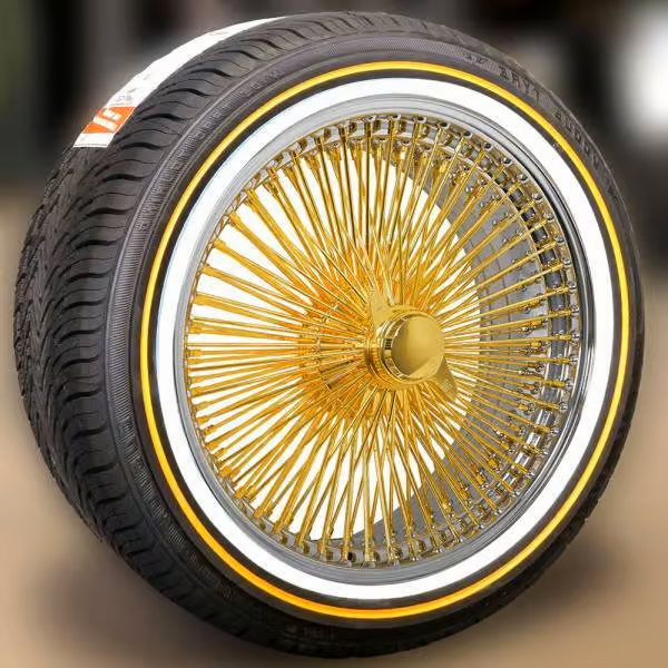 A close up of a tire with a gold spoke wheel