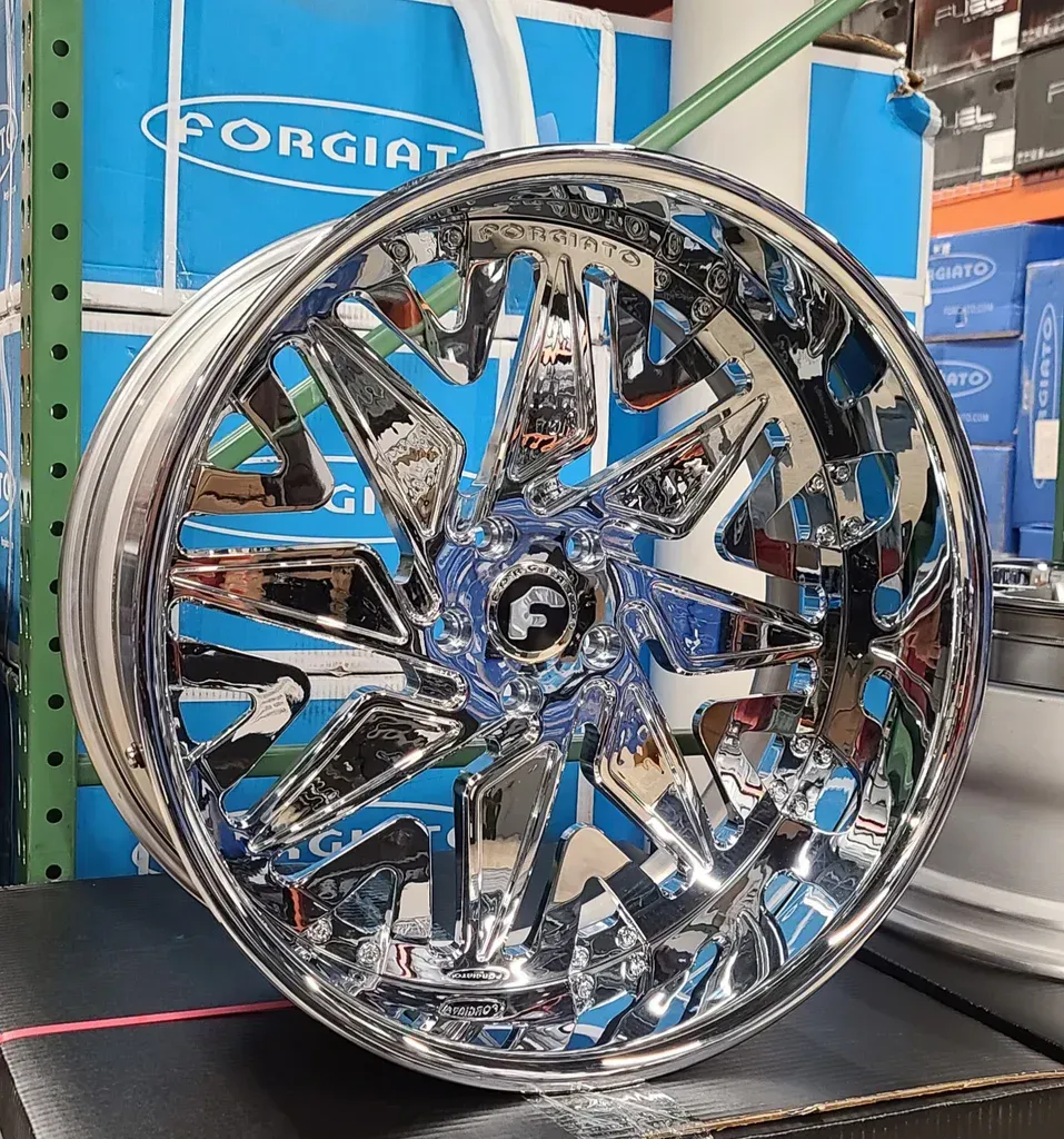 A close up of a chrome wheel on a shelf