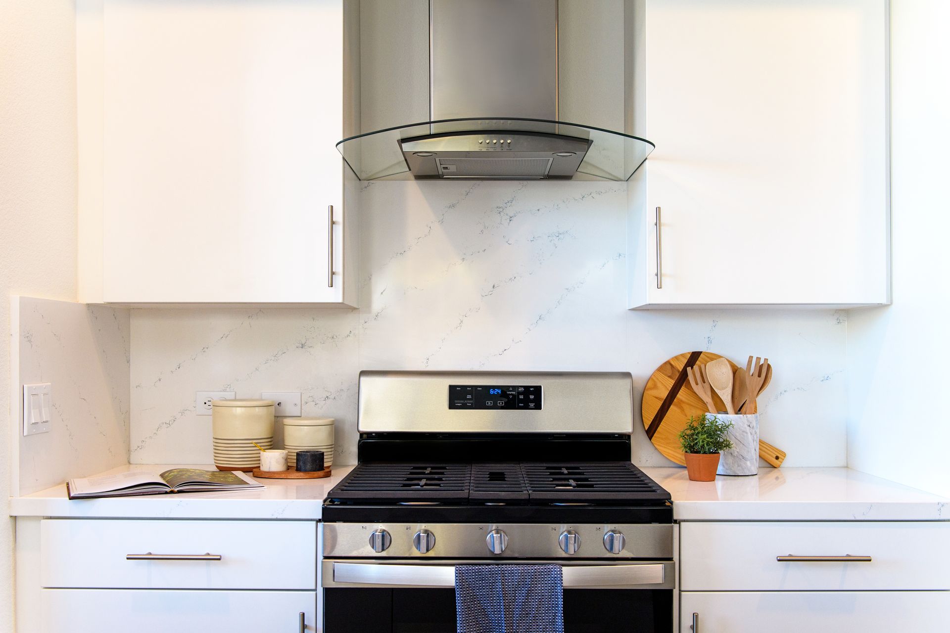 photo showing the stove area of the kitchen with plenty of natural lighting