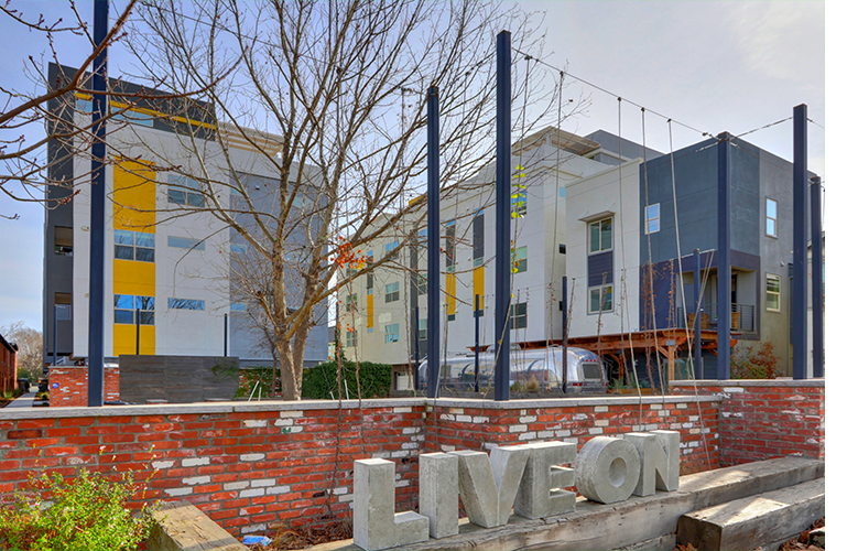 Photo showing artwork in the neighborhood with building in the background