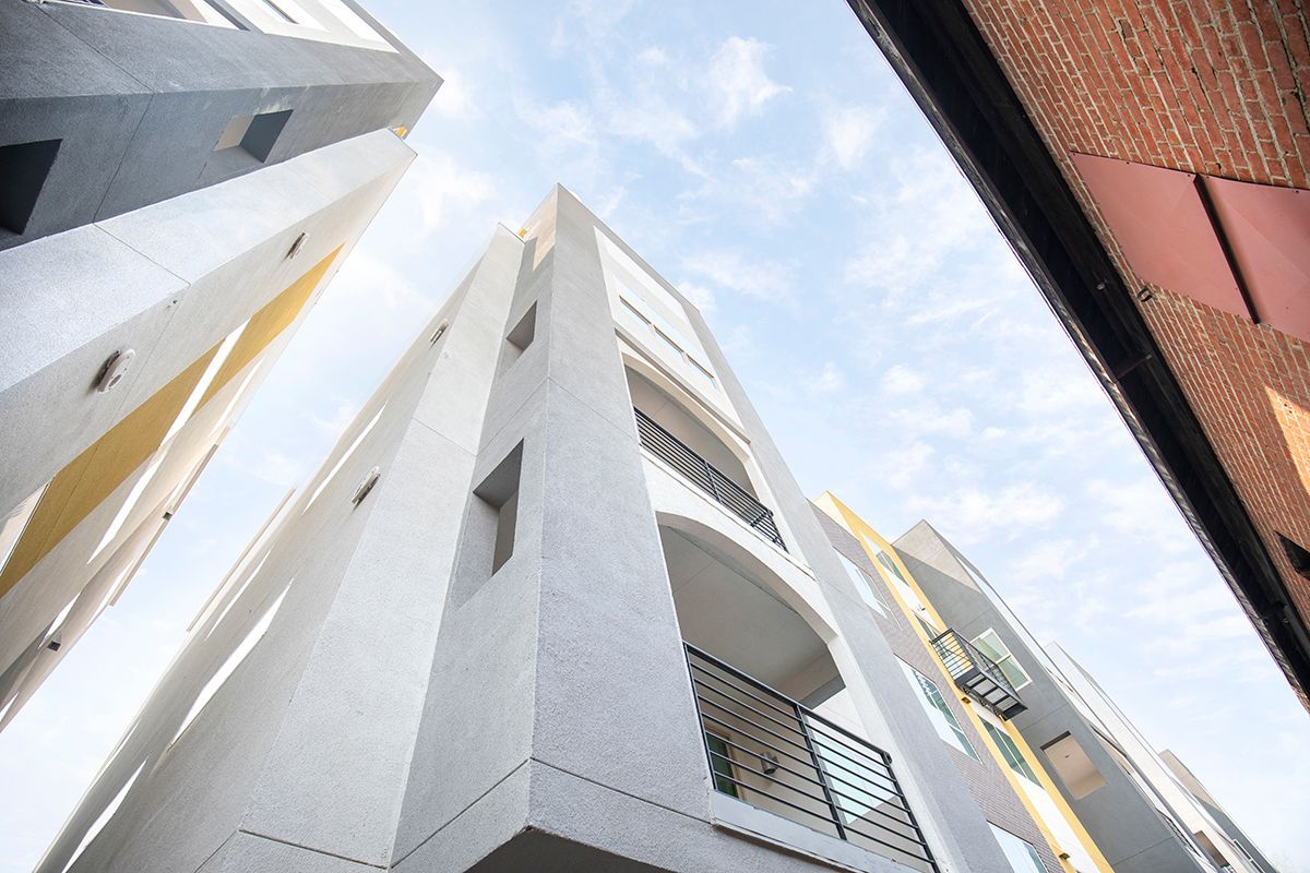 photo looking up at the building with balcony in foreground