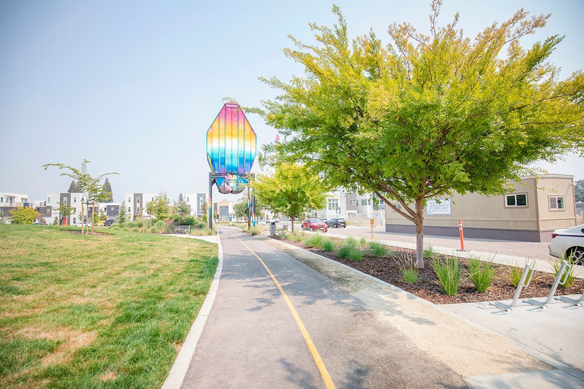 photo showing bike path/walkway with neighborhood art above
