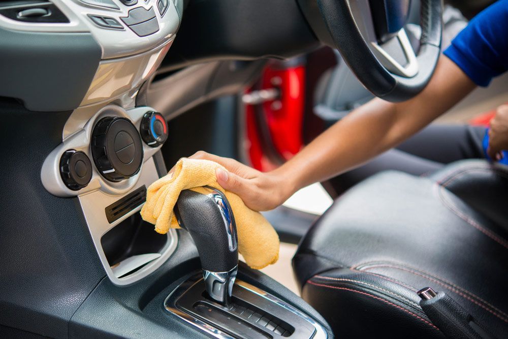 Hand With Microfiber Cloth Cleaning Car Interior  — Commercial Car Wash in Norville, QLD
