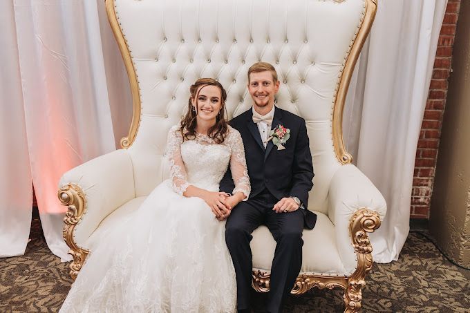 Two gold wedding rings are sitting on top of a marble surface.