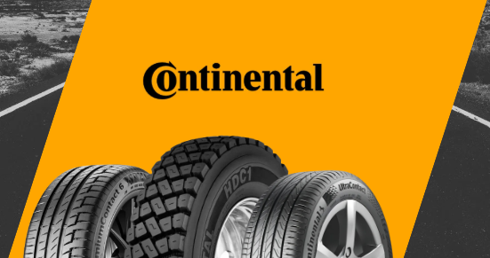 Uma loja de pneus continental com um carro estacionado em frente.