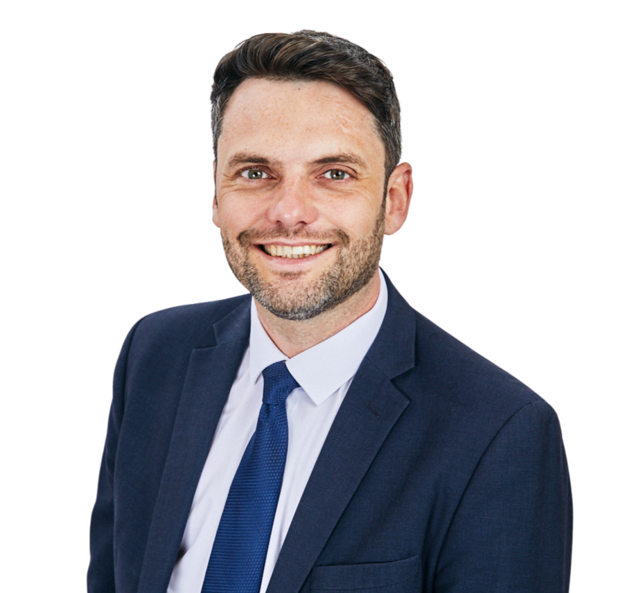 A man in a suit and tie is smiling for the camera.
