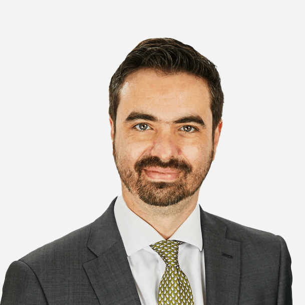 A man with a beard is wearing a suit and tie