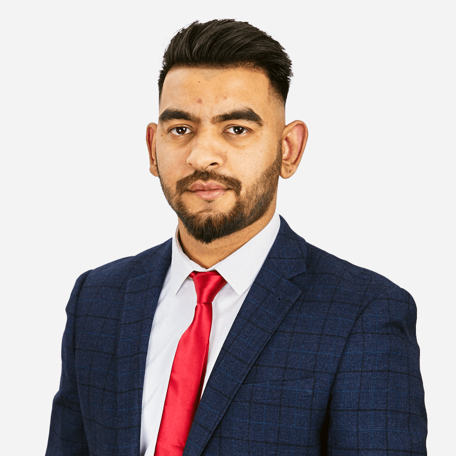A man with a beard is wearing a blue suit and red tie.