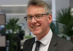 A headshot of Sir Julian Hartley, the newly appointed Chief Executive of CQC