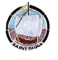 A stained glass emblem of a sailboat in a circle.