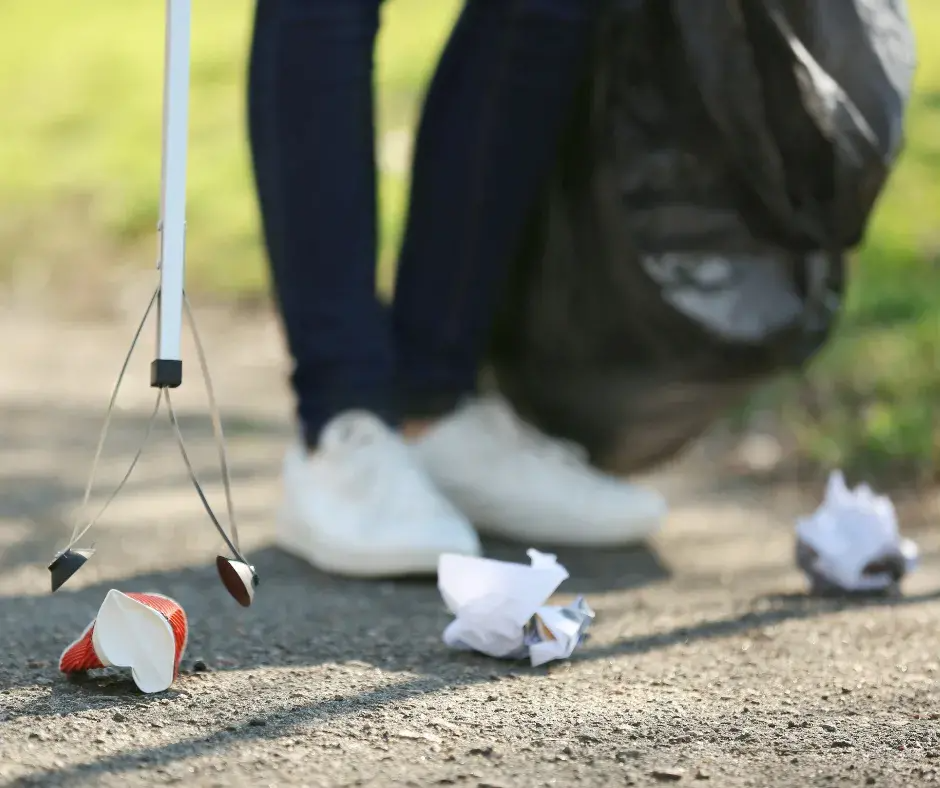 Someone is litter picking along a path