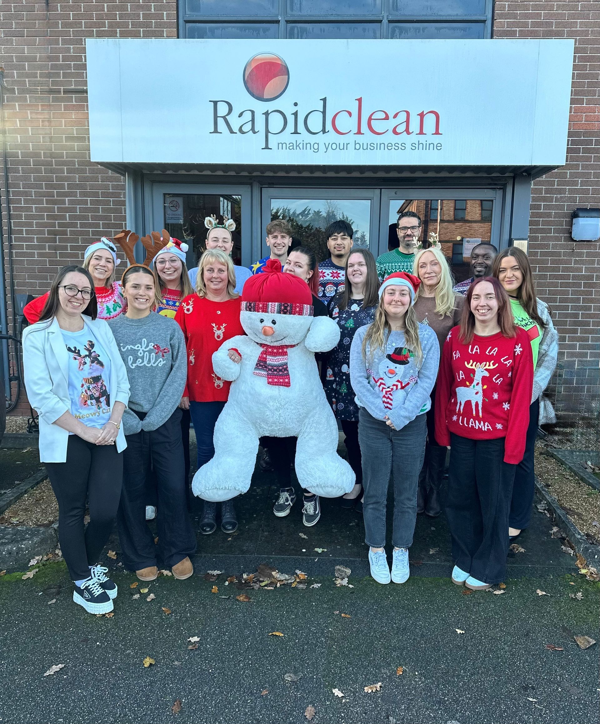 A bunch of gold stars hanging from a string on a dark background.