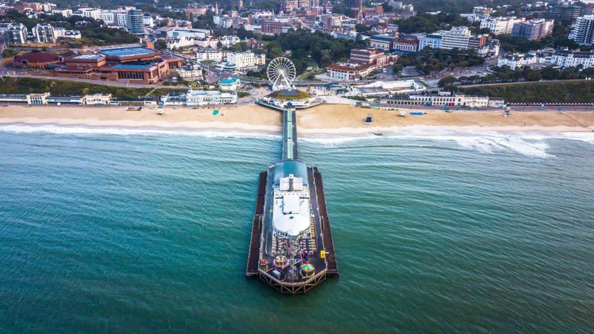 An aerial view of a pier in the middle of the ocean.