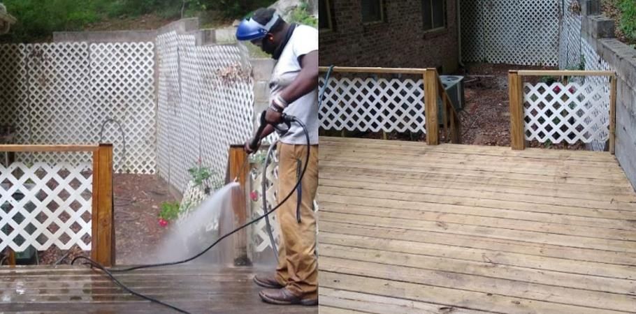 A man is using a lawn mower to cut the grass in a garden.