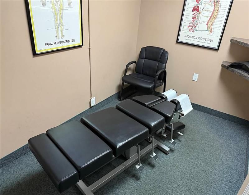 Person pointing to a spinal model, highlighting the lumbar region.