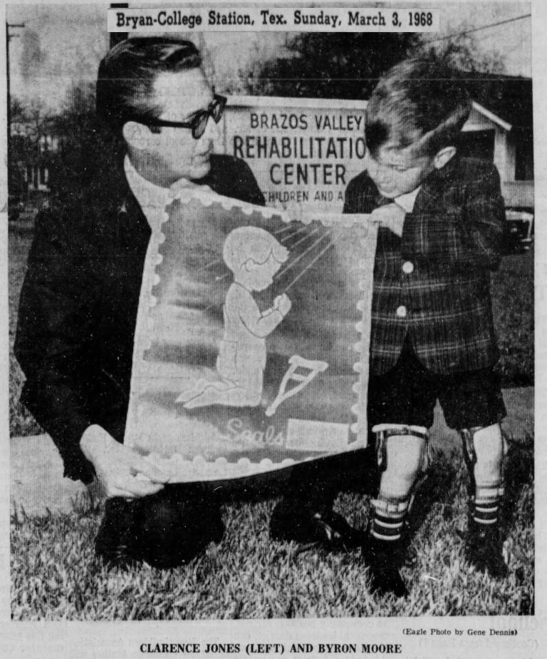 Man and boy holding a poster for Brazos Valley Rehabilitation Center.