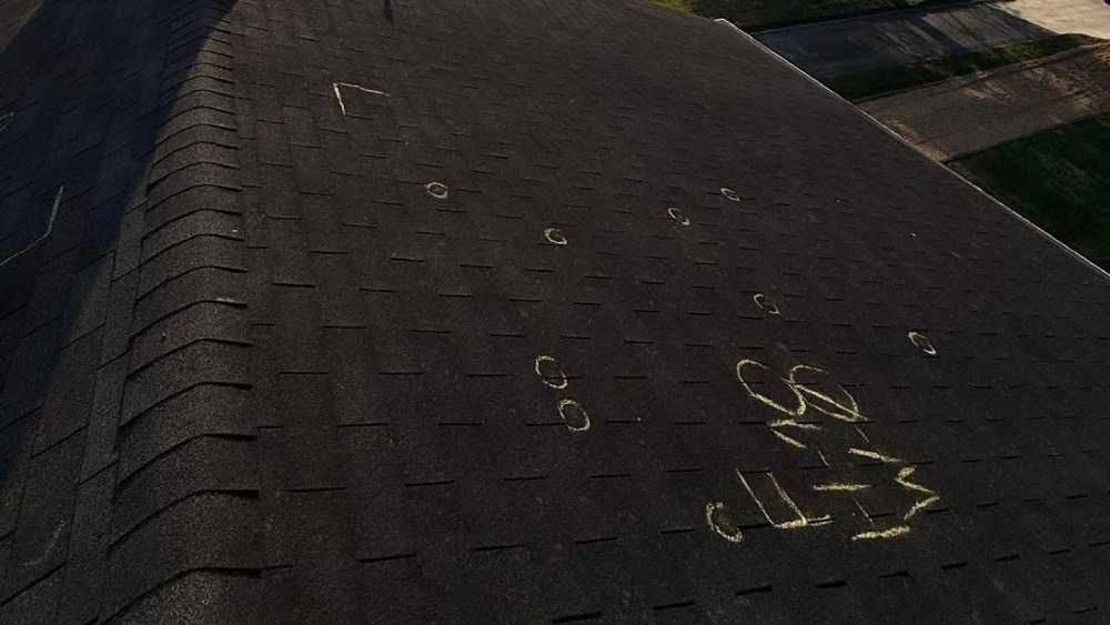 A residential roof with hail damage for inspection in Huntsville AL by LJ Roofing