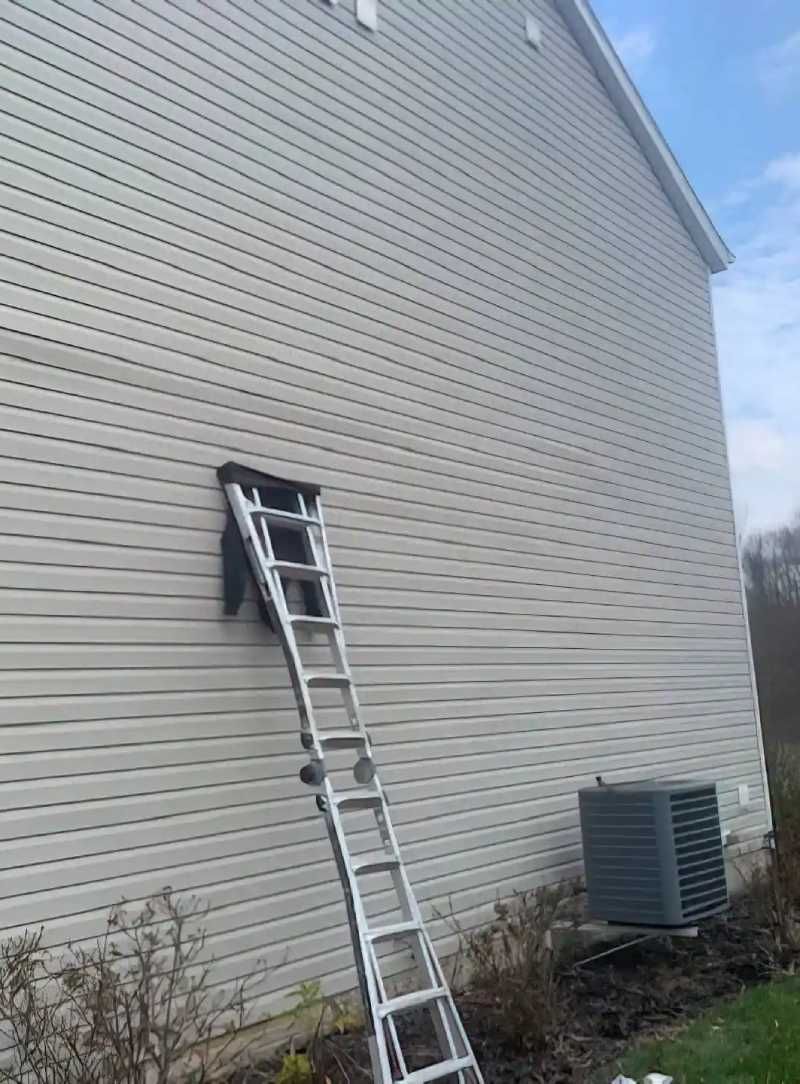 Beige vinyl siding on a home in Huntsville, AL by LJ Roofing