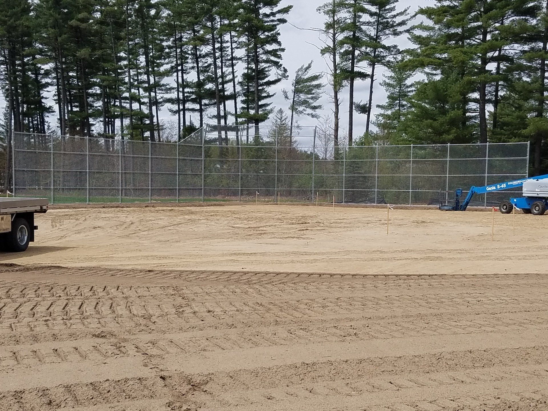 a truck is parked in the middle of a dirt field .