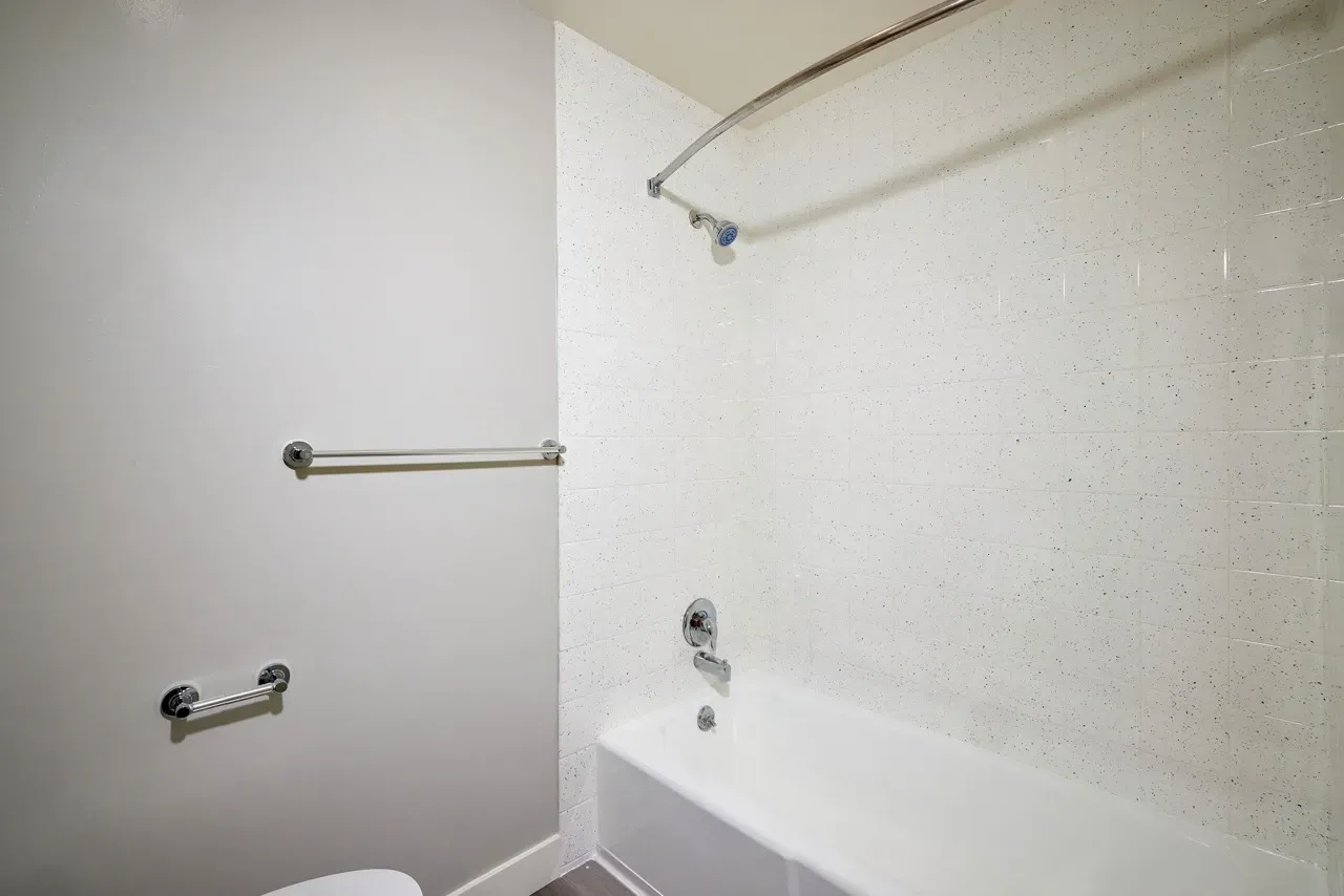 Modern bathroom with a bathtub and shower.