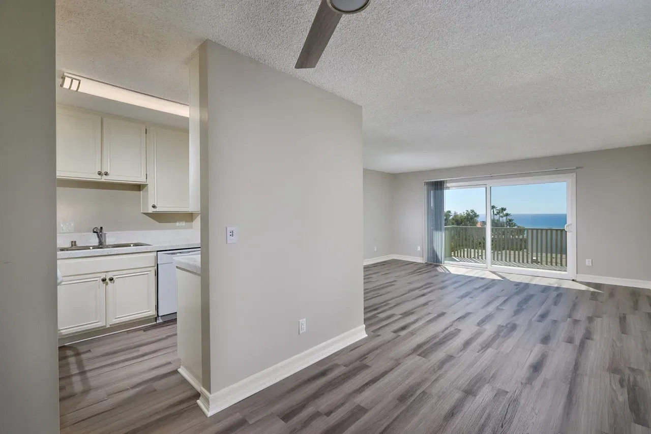 Kitchen and living area with ocean view balcony