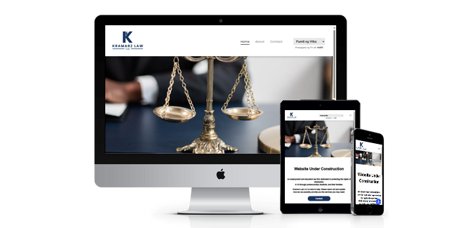 A computer , tablet , and cell phone are displaying a website for a law firm.