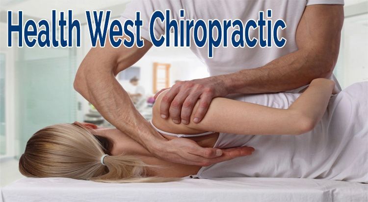 A woman is laying on a bed getting a massage from a chiropractor.