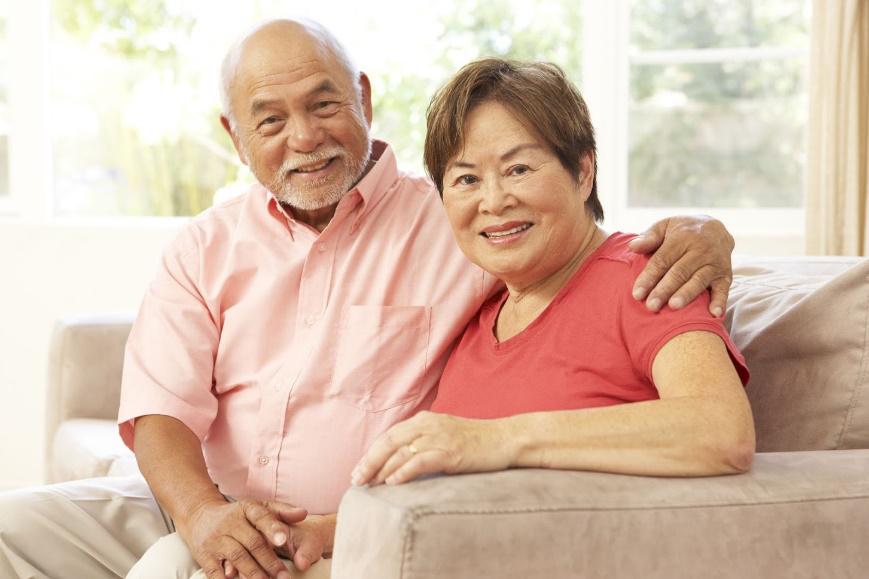 Senior Couple on Sofa — Peoria, IL — Robert Cottingham Property Management Co