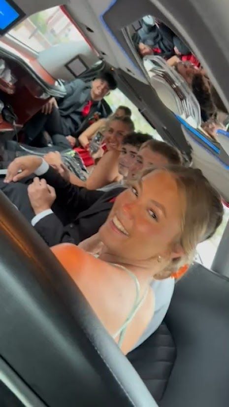 A group of people are sitting in a limousine.