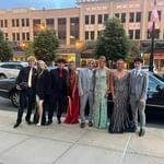 A group of people are posing for a picture in front of a building.