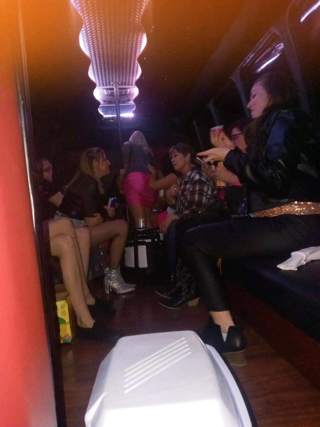 A group of people are sitting in a shuttle bus