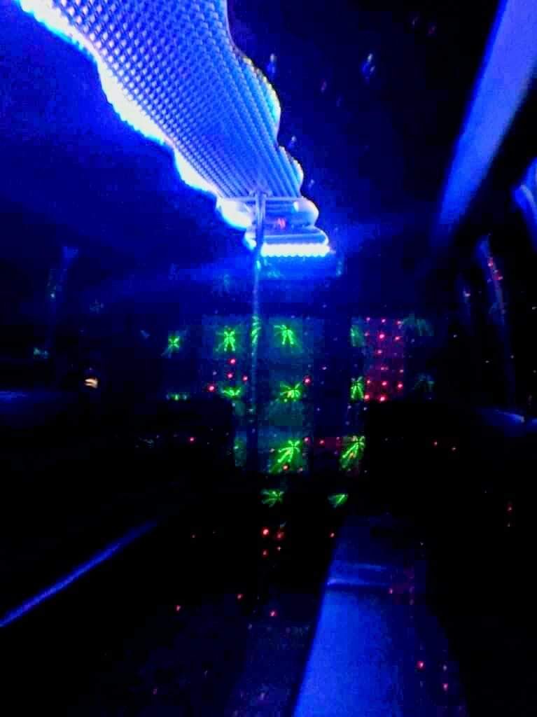 A dark room with a blue light hanging from the ceiling