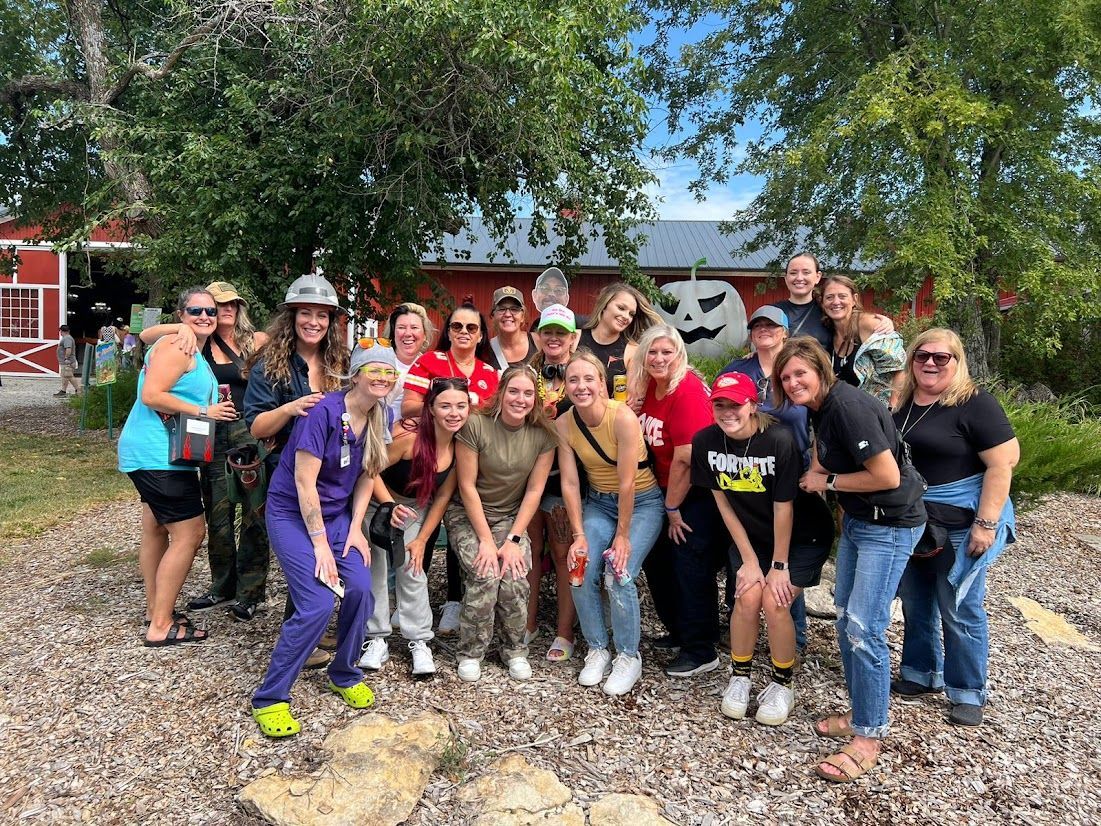 A group of people are posing for a picture in front of a building.