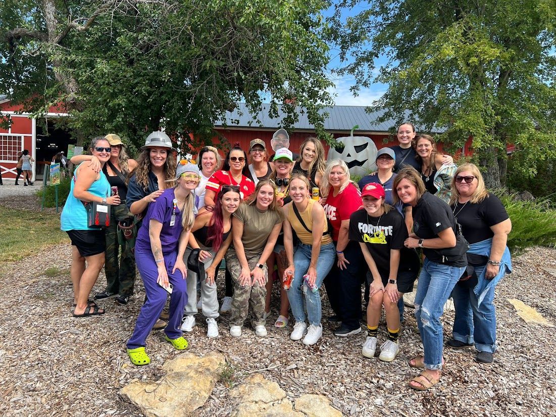 A group of people are posing for a picture in front of a building.