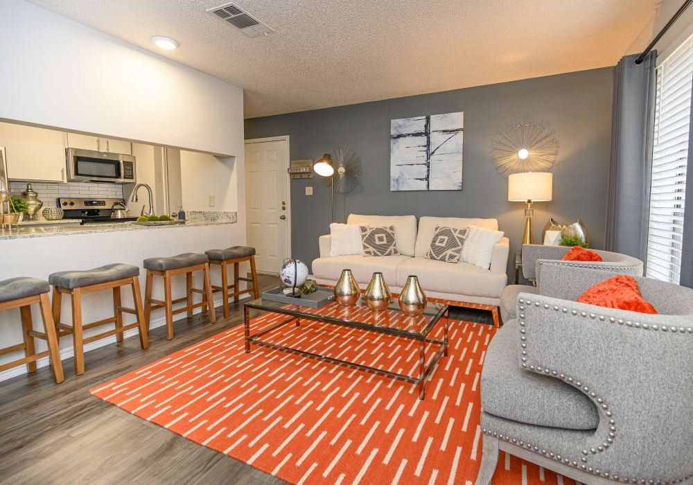 Living Room with Couches and Orange Decor | The Logan