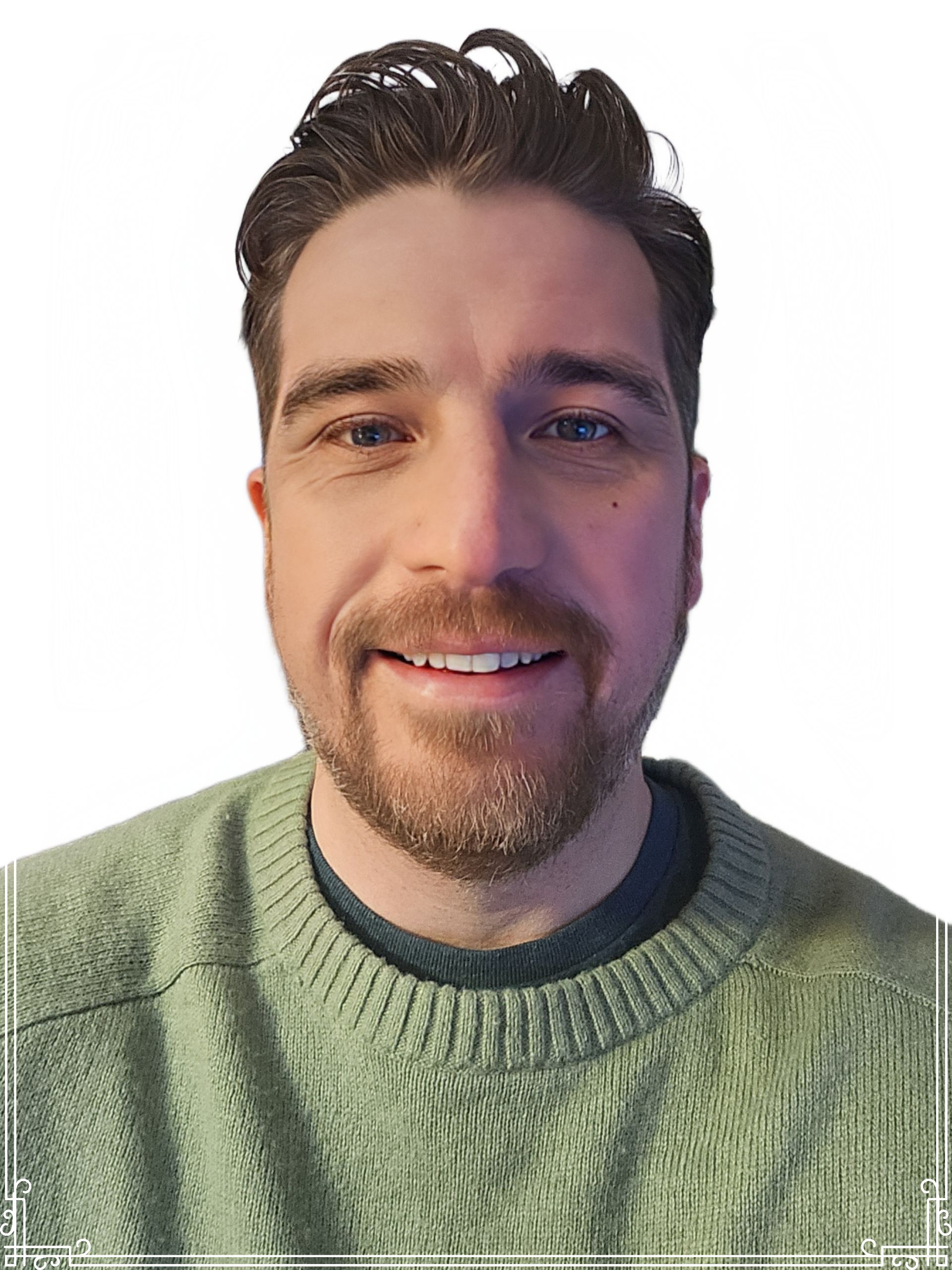Man with short brown hair and a beard, smiling in a light green sweater.