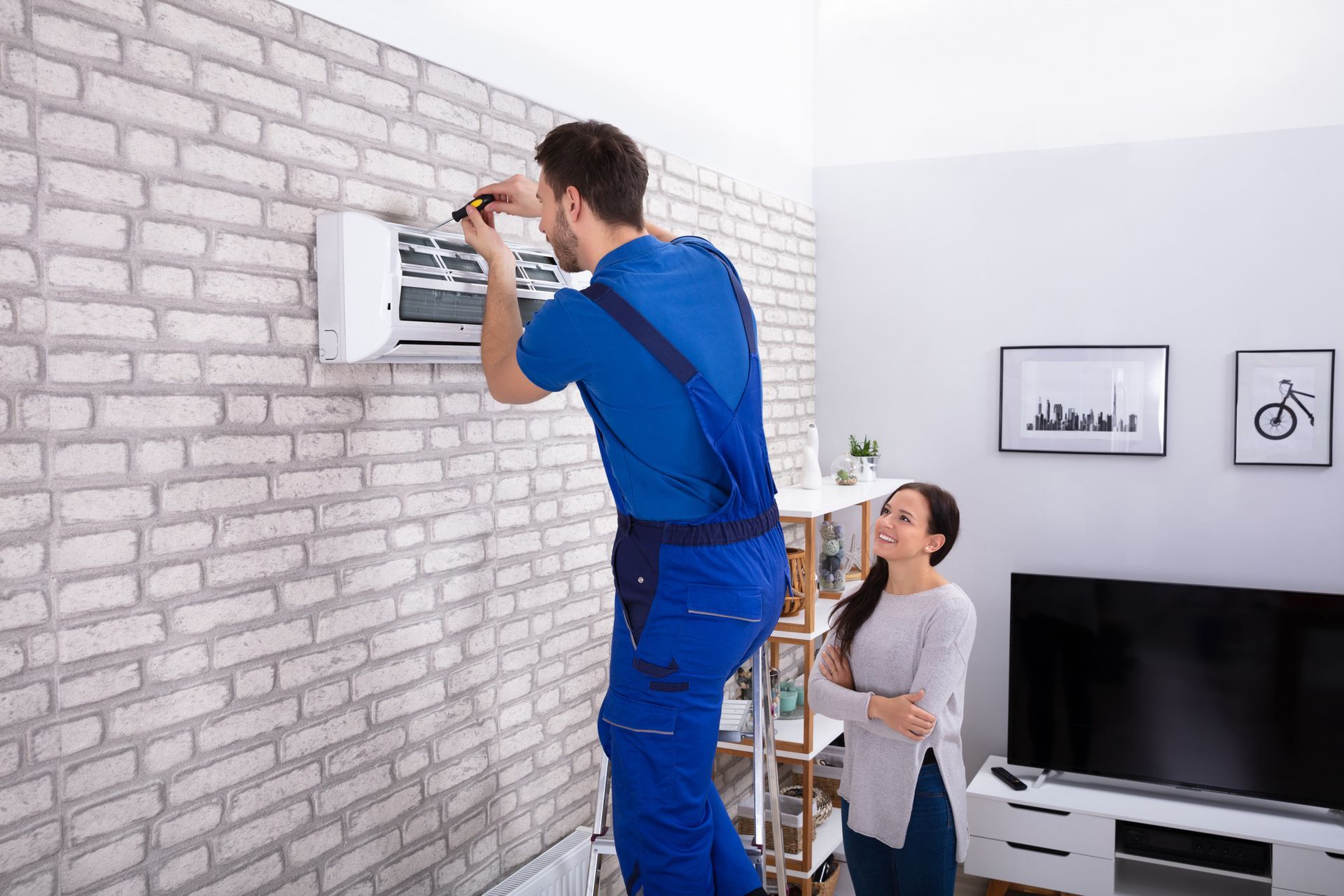 EZ-Air Technician Repairing Air Conditioner With Screwdriver.