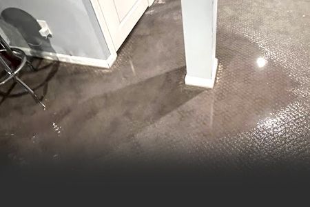 A man is cutting a tree branch on the side of the road.