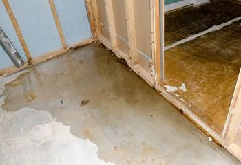 A room with a leak in the floor and walls.