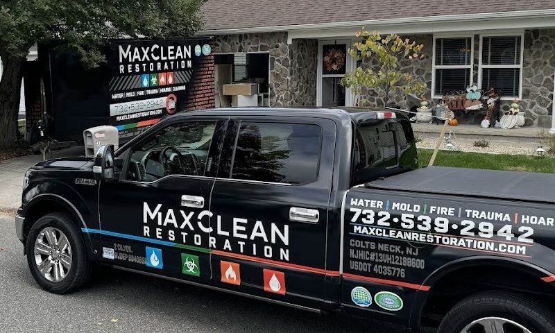 A black truck is parked in front of a house.