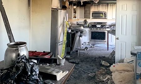 A kitchen in a house that has been damaged by a fire.