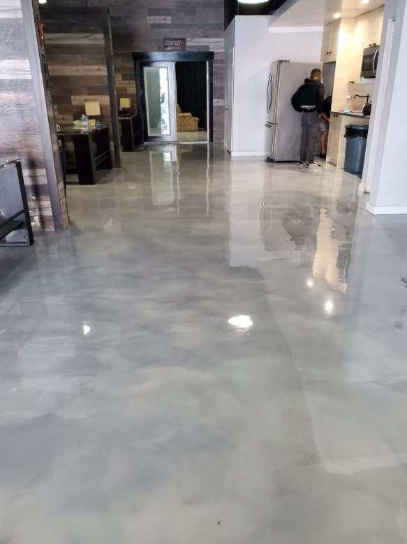 Modern grey metallic epoxy flooring in a professional office interior.