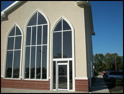 A church with a lot of windows and a door.