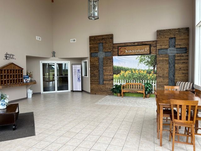 A group of people are standing in a church talking to each other