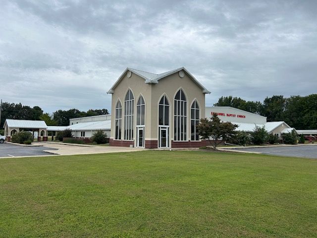 A church with a lot of windows and a door.