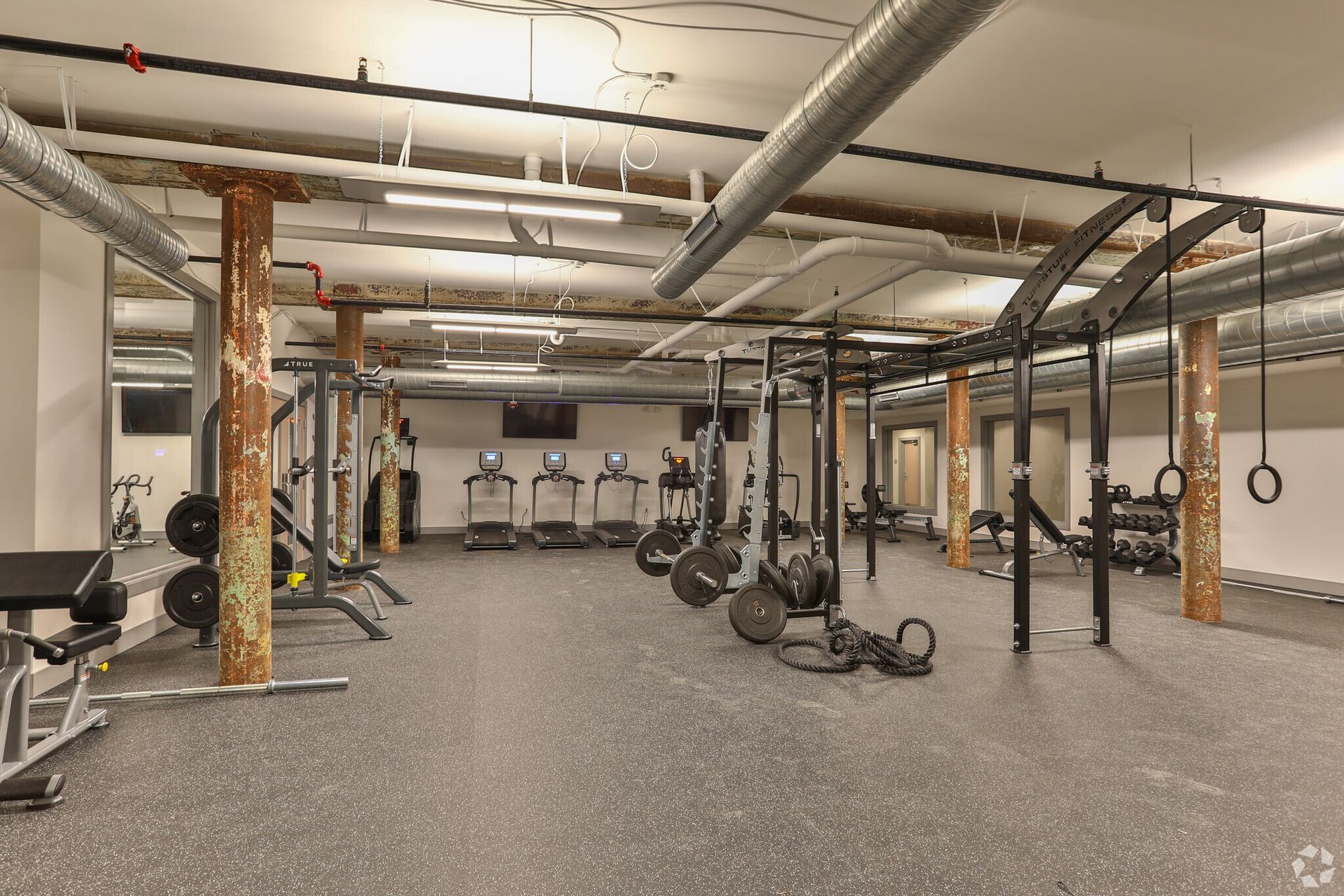 An artist 's impression of a gym with a lot of equipment.