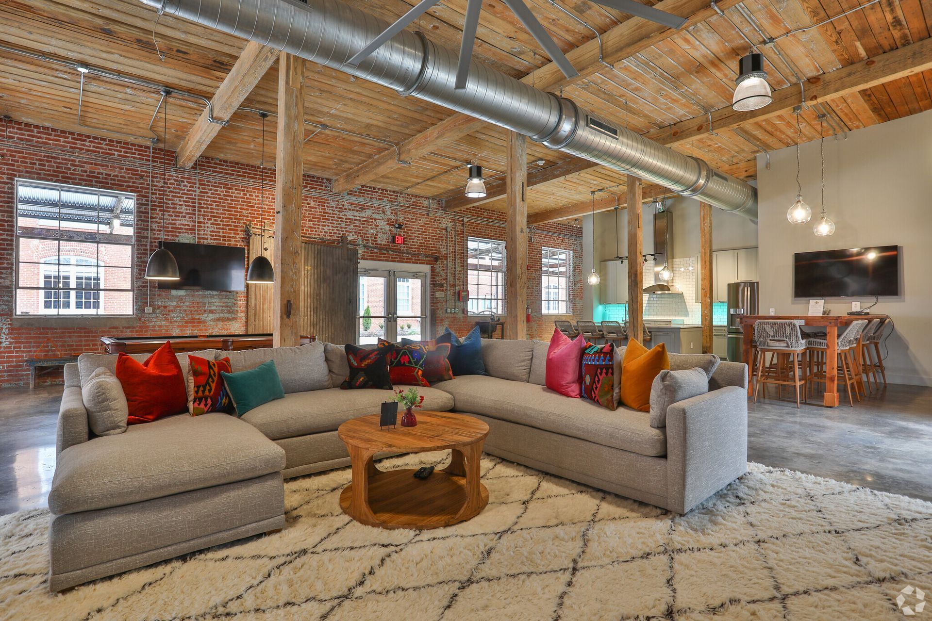 A living room with a large sectional couch and a coffee table.