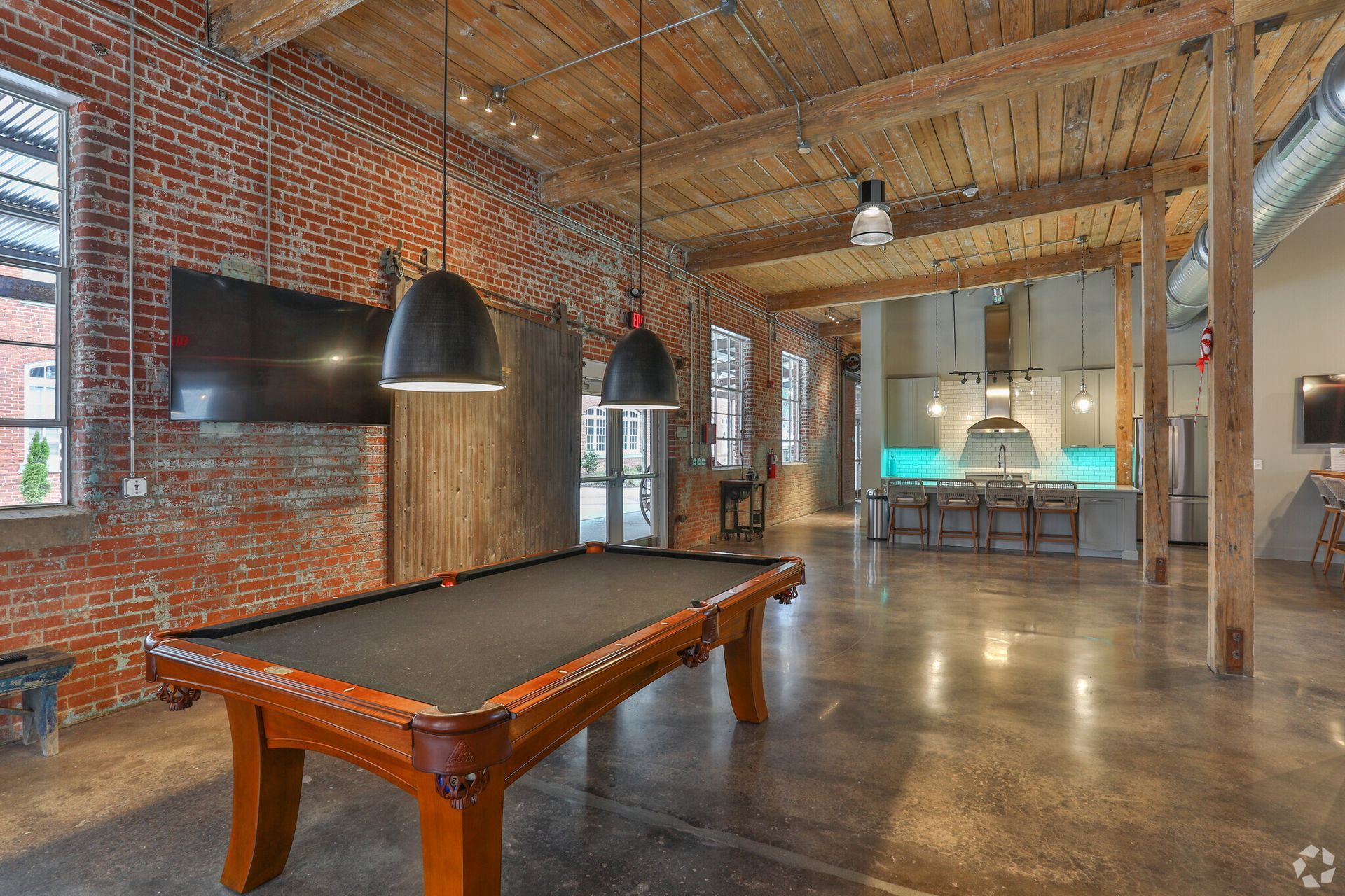 There is a pool table in the middle of the room.