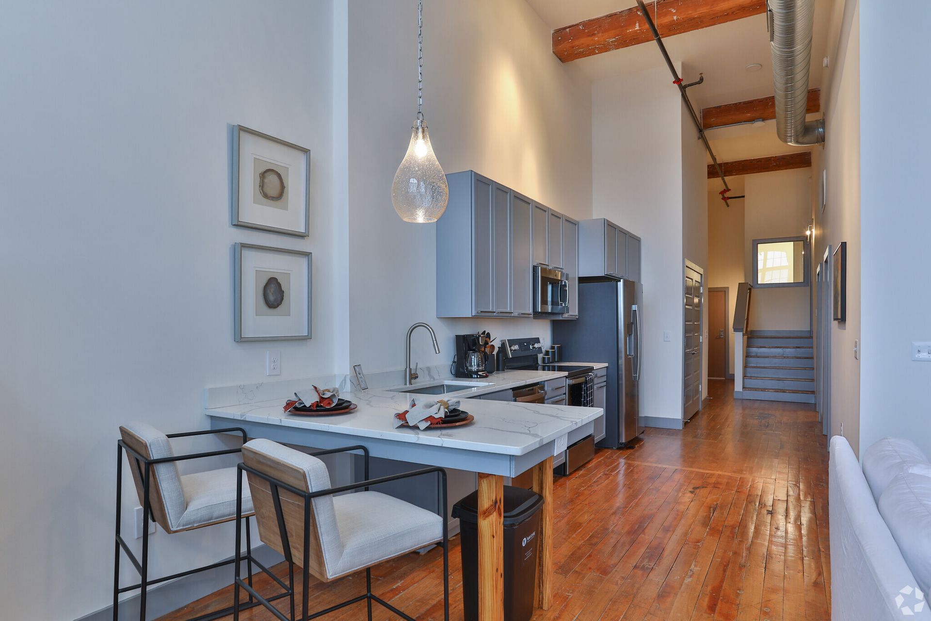 A kitchen with a table and chairs in it.